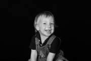 Black and white studio photo of a child smiling