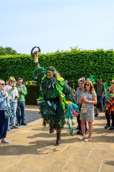 At the New Forest Green Man Parade 2026, held at The Burley Manor in Burley, Hampshire, a spirited performer dressed as the traditional Green Man leaps mid-dance while holding a tambourine. This vibrant celebration of local folklore and seasonal tradition draws a crowd of onlookers to the historic estate grounds, marking a joyful moment during the festivities.#jerryfennerphotography #newforestphotographer #greenmanparade #burleymanor #hampshirelife #folkloretraditions