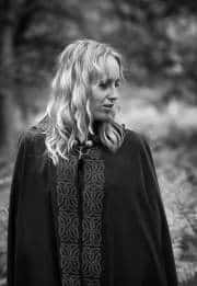 Her quiet gaze, where ancient whispers linger.