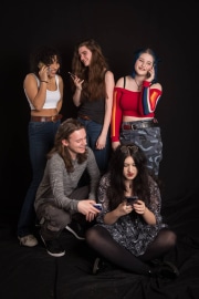 A group of five friends captured in these candid-style teenage photographs at The Studio on the Hill, highlighting the modern reality of social interaction where everyone is simultaneously engaged with their mobile phones. The image serves as a creative commentary on how the digital generation balances social presence with the constant distraction of their devices. #jerryfennerphotography #newforestphotographer #teenlife #studiophotography #digitalgeneration #youthculture