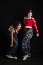 Two teenage girls share a joyful, spontaneous moment of laughter while posing during a fun session of Teenage photographs at The Studio on the Hill, capturing their vibrant personalities and friendship in this studio portrait.#jerryfennerphotography#newforestphotographer#teenphotography#studioportrait#candidlaughter#friendshipgoals